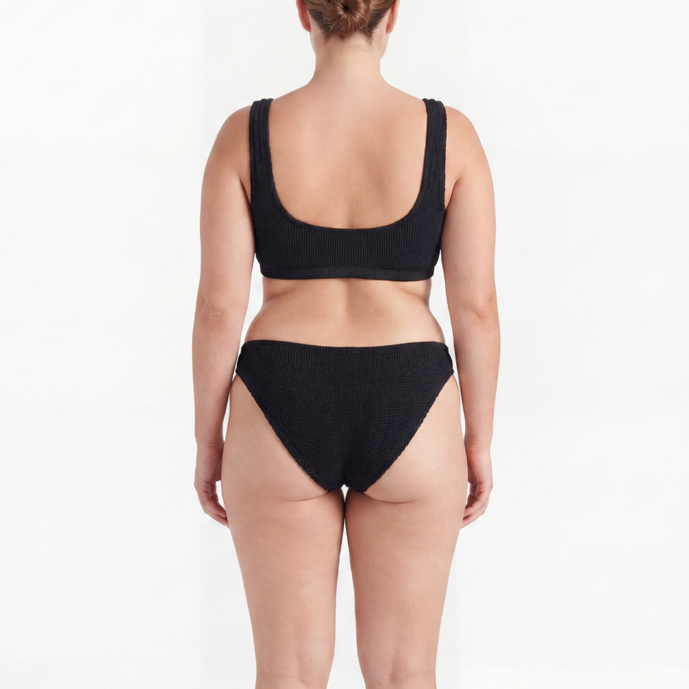 Back view of the Amalfi bikini with low waisted bottoms in midnight black