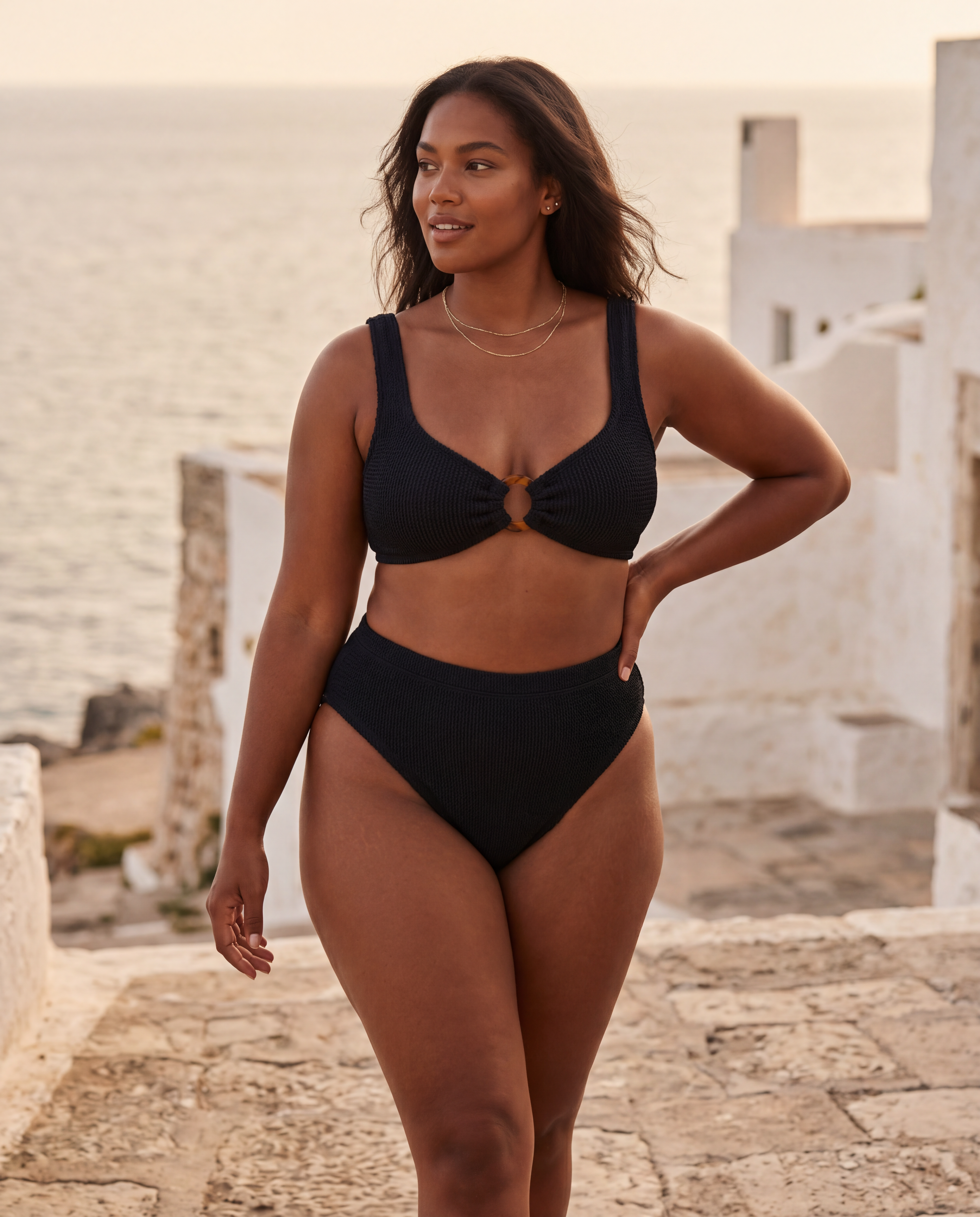 Plus size model wearing the Portofino bikini with high waisted bottoms by the Mediterranean